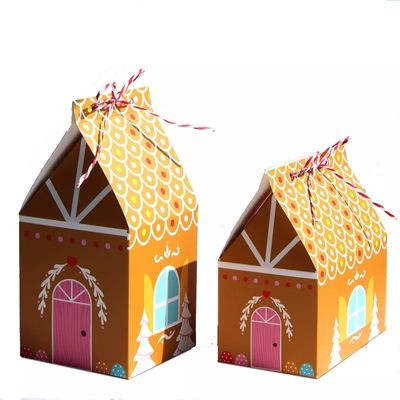 La casa forma las cajas de regalo de la Navidad para el cartón disponible del caramelo